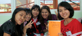 Teachers holding notebook during SIOP PD prgogram